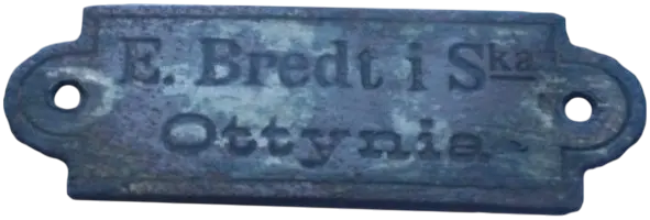 Латунна табличка з написом "E. Bredt i Ska. Ottynia."